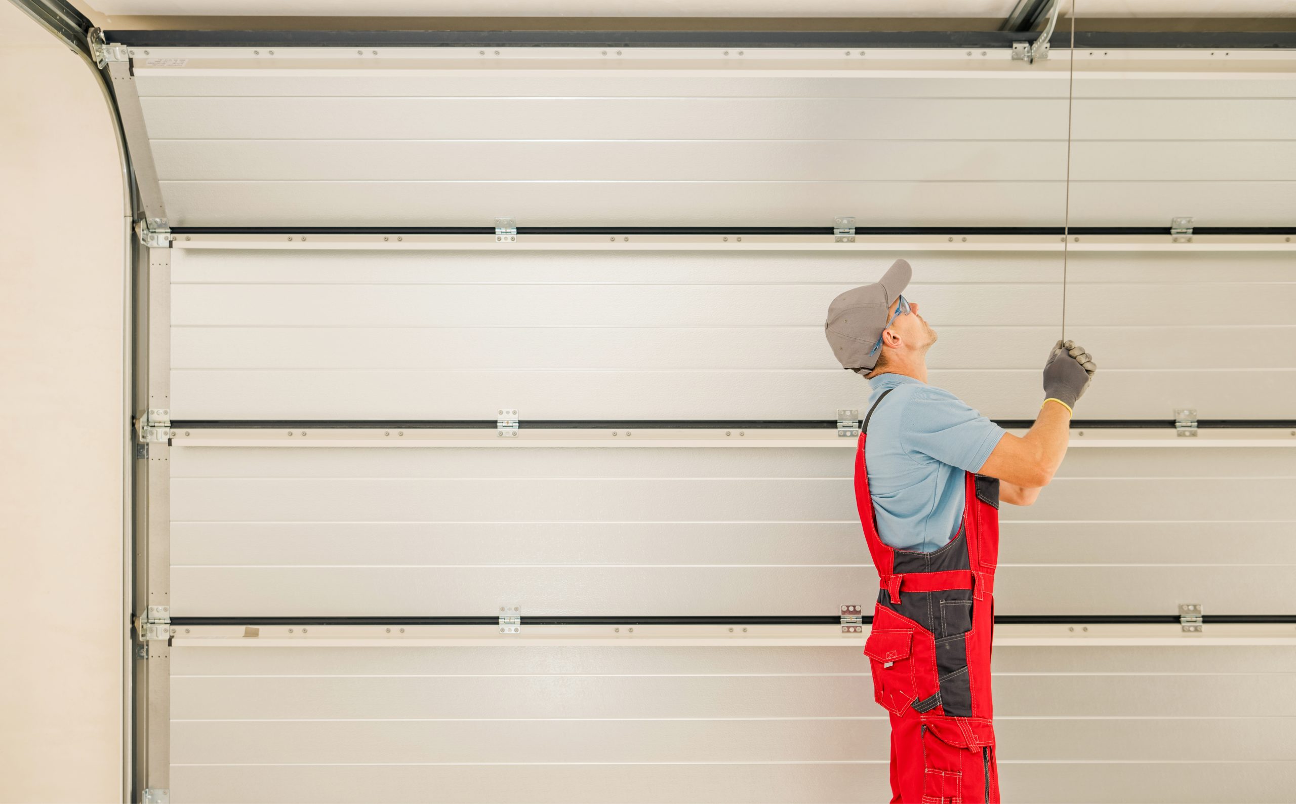 A worker checking and preparing the garage door