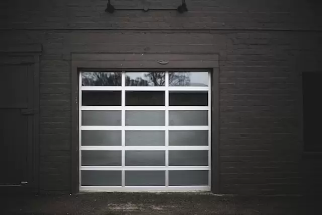 Compact sectional garage door in dark gray color