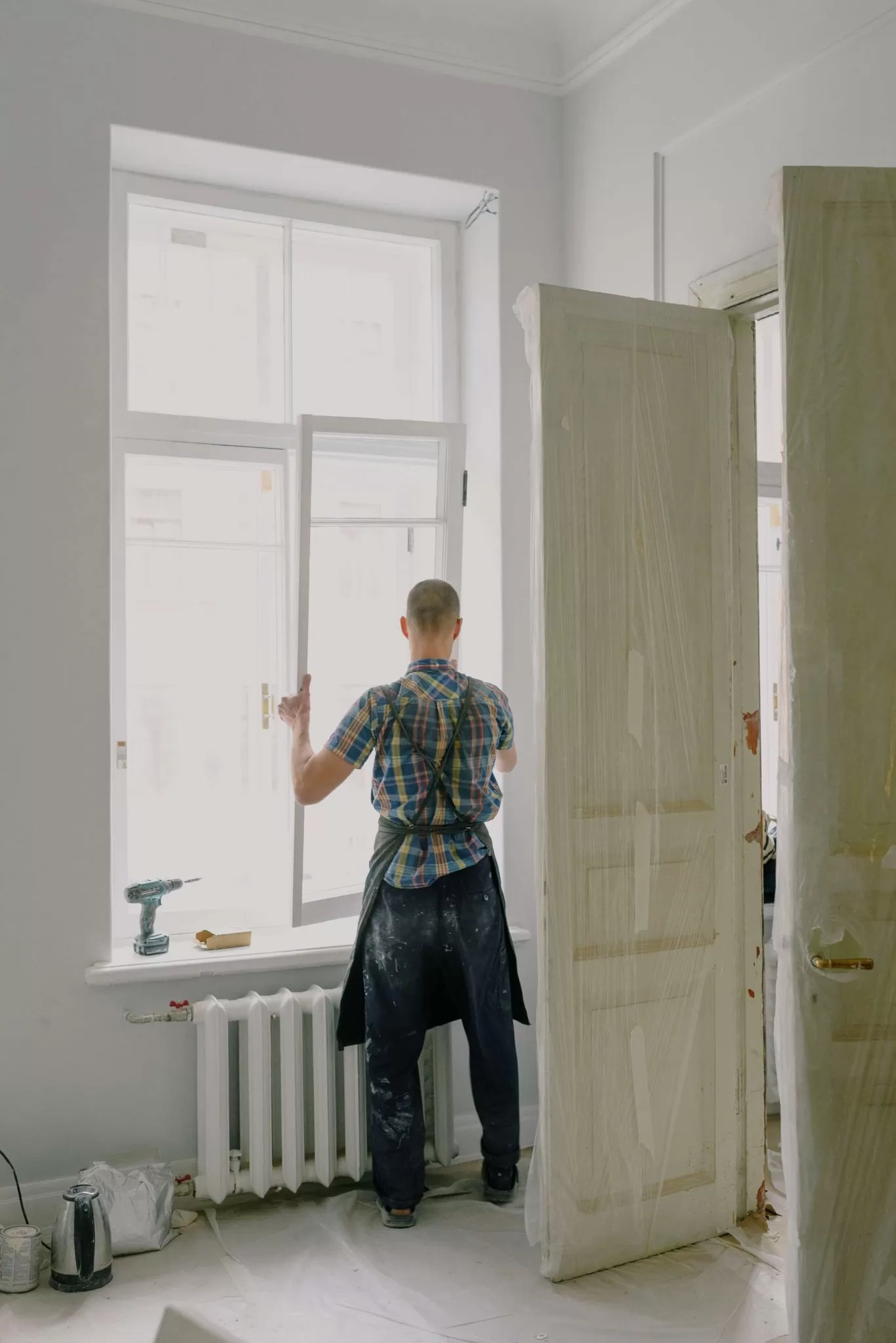 A man installing a window in a residential property