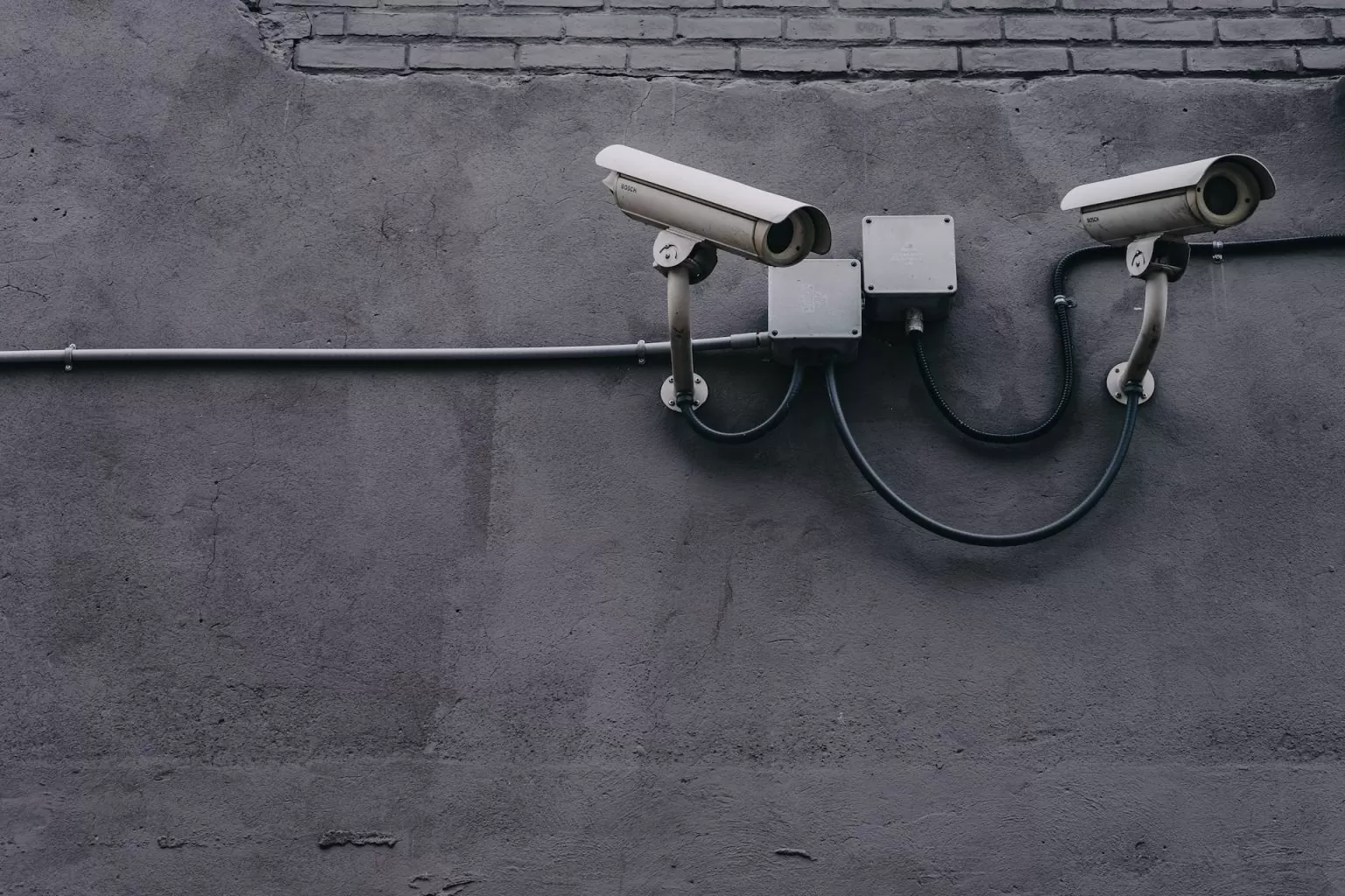 Two security cameras installed on a wall